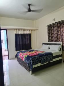 a bedroom with a bed in a room at Umashankar Homestay in Nashik