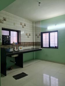 a bathroom with a desk and a window in a room at Umashankar Homestay in Nashik