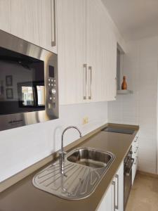 a kitchen with a sink and a microwave at Casa Indalo Vera Coast in Vera