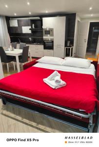a bedroom with a large bed with a red blanket at A Casa di Maria 2 in Cavallino di Lecce