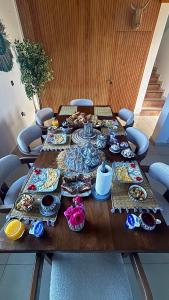 a wooden table with plates and dishes on it at oualidia surfhouse in Oualidia