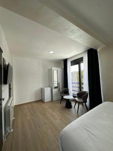 a hotel room with a bed and a table and chairs at Srebrna Jela in Žabljak