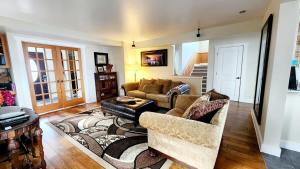 a living room with a couch and a table at The Fireside Lakehouse in Bridgeport