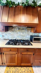 a kitchen with wooden cabinets and a stove top oven at The Fireside Lakehouse in Bridgeport +22 photos
