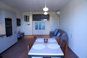 a living room with a white table and a couch at WANDERLUST OASI, COUNTRYSIDE APARTMENTS - Bardolino, Lago di Garda - Verona in Bardolino