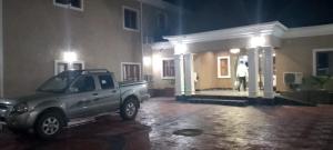 a truck parked in front of a house at night at Transvent Hotel and Suites in Abeokuta