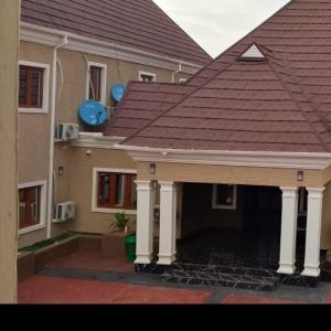 a house with a red roof and a patio at Transvent Hotel and Suites in Abeokuta