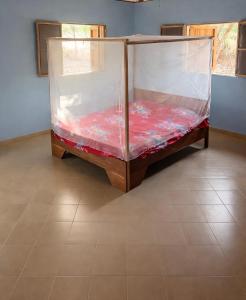 a bed covered in plastic in a room at Campement Clair de Lune - Chez Dam et Amcé in Kachiouane