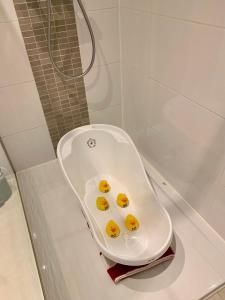 a bath tub with yellow ducks in it in a bathroom at Residentie Rapallo Oostende with fantastic Sea View! in Ostend +73 photos
