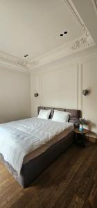 a bedroom with a large bed with two pillows at Huma Living in Vlorë