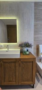 a bathroom with a sink and a mirror at Huma Living in Vlorë +23 photos