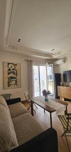 a living room with a couch and a table at Huma Living in Vlorë