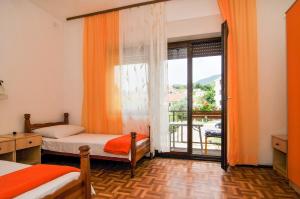 a bedroom with two beds and a large window at Guesthouse Lanca in Tivat