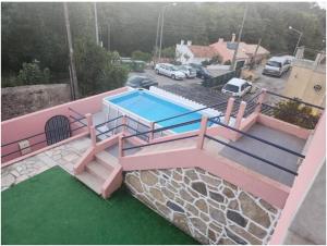 a swimming pool on top of a house at Casa Rosa da Serra in Sintra