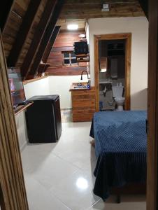 a room with two beds and a sink and a toilet at Chalés FRONT LAKE 2 in Córrego do Bom Jesus