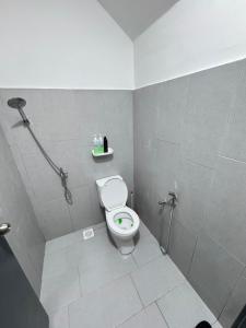 a small bathroom with a toilet and a shower at KY Stay D'Serkam in Serkam +6 photos