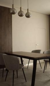 a dining room with a wooden table and chairs at Franko Aparts in Uzhhorod