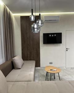 a living room with a couch and a table at Franko Aparts in Uzhhorod