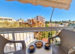 a plate of food sitting on a table on a balcony at Feel's Like Home Apartment in Chios Town in Chios