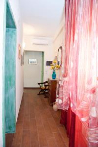 a hallway with a red curtain and a table at La Casa di Baldo in Ugento