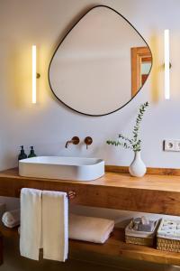 a bathroom with a sink and a mirror at Otegui Etxea Casa Rural in Aspuru +33 photos