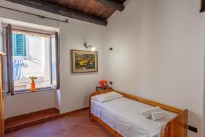 a bedroom with a bed and a window at Casa Milly in Alghero