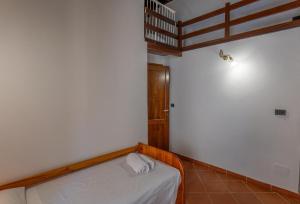 a small bedroom with a bed in a room at Casa Milly in Alghero +12 photos