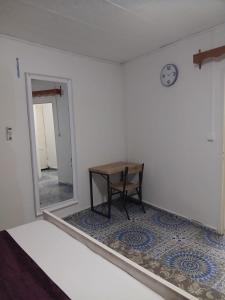 a small table in a room with a mirror at Les Jasmins partagées in Mamoudzou
