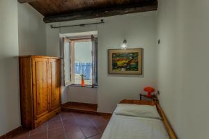 a bedroom with a bed and a window at Casa Milly in Alghero