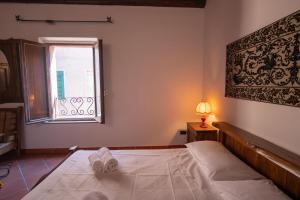 a bedroom with a white bed and a window at Casa Milly in Alghero