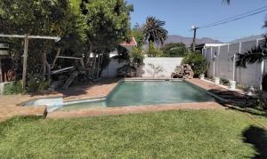 a swimming pool in the yard of a house at Adventure Cape Town 1 in Cape Town