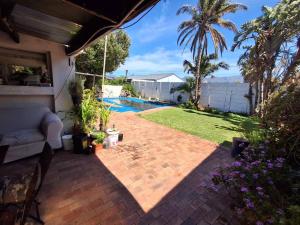 a backyard with a swimming pool and a patio at Adventure Cape Town 1 in Cape Town