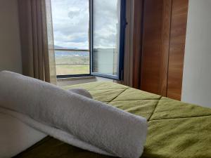 a bedroom with a bed and a large window at Quinta dos Carvalhais - Serra da Estrela in Fornos de Algodres +158 photos