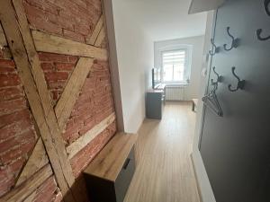 a room with a brick wall and a wooden door at Apartament w centrum in Krotoszyn