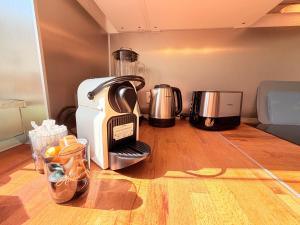 a coffee maker sitting on top of a kitchen floor at Amaroo - Serviced Apartment "Andy" in Potsdam