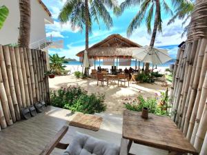 a restaurant on the beach with a table and umbrella at Ocean Breeze Bungalow in Sông Cầu