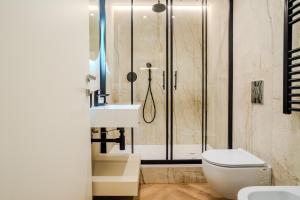a bathroom with a shower and a toilet and a sink at Italianflat - Duomo Atmosphere Two in Milan +21 photos