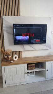 a flat screen tv sitting on top of a entertainment center at Studio Arija -na par koraka od PARKA - Banja Koviljača in Banja Koviljača