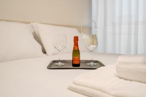 a bottle of champagne and two wine glasses on a tray at Italianflat - Duomo Atmosphere Two in Milan