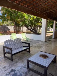 a cat sleeping on a bench on a patio at Aconchego&Lazer in Piaçabuçu