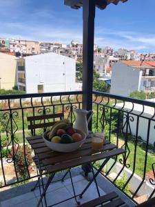 a bowl of fruit sitting on a table on a balcony at Armonia Guest House in Skiathos