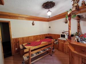 a bedroom with a bed and a microwave in it at Къща Ники in Stoykite