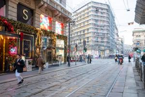 a busy city street with people walking on the street at Italianflat - Duomo Atmosphere Two in Milan