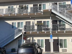 a black car parked in front of a building at Solis Place in Old Town in San Diego