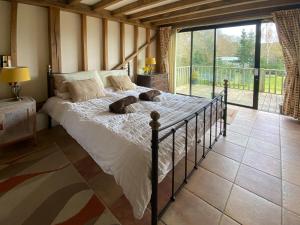 a bedroom with a bed with two dogs laying on it at The Old Carthouse in Steyning +4 photos
