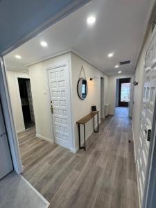 a hallway of a home with a door and a table at Casa Herrero Valderrobres in Valderrobres