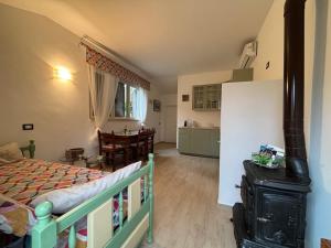 a bedroom with a bed and a kitchen and a table at La Casa dei Daini in Ronciglione +25 photos
