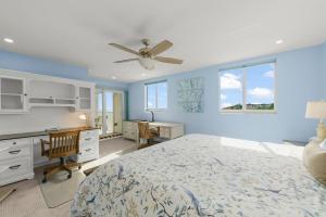 a bedroom with a bed and a desk and a ceiling fan at Island Beach Club #360D in Sanibel