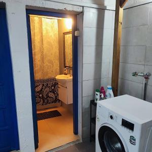 a bathroom with a washing machine and a sink at Historical House in Alsancak in Konak