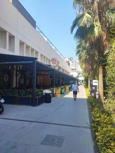 a person walking down a sidewalk in front of a building at Historical House in Alsancak in Konak